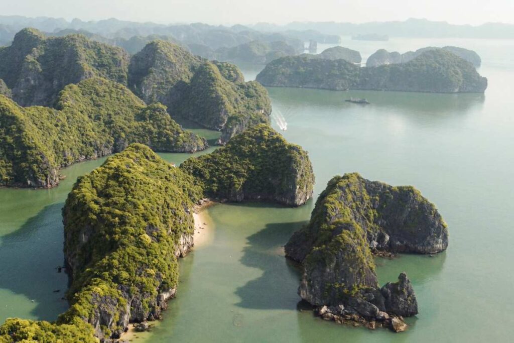 Boat between Cat Ba Island Limestone Mountains