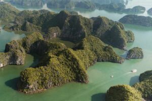 Boat between Cat Ba Island Limestone Mountains