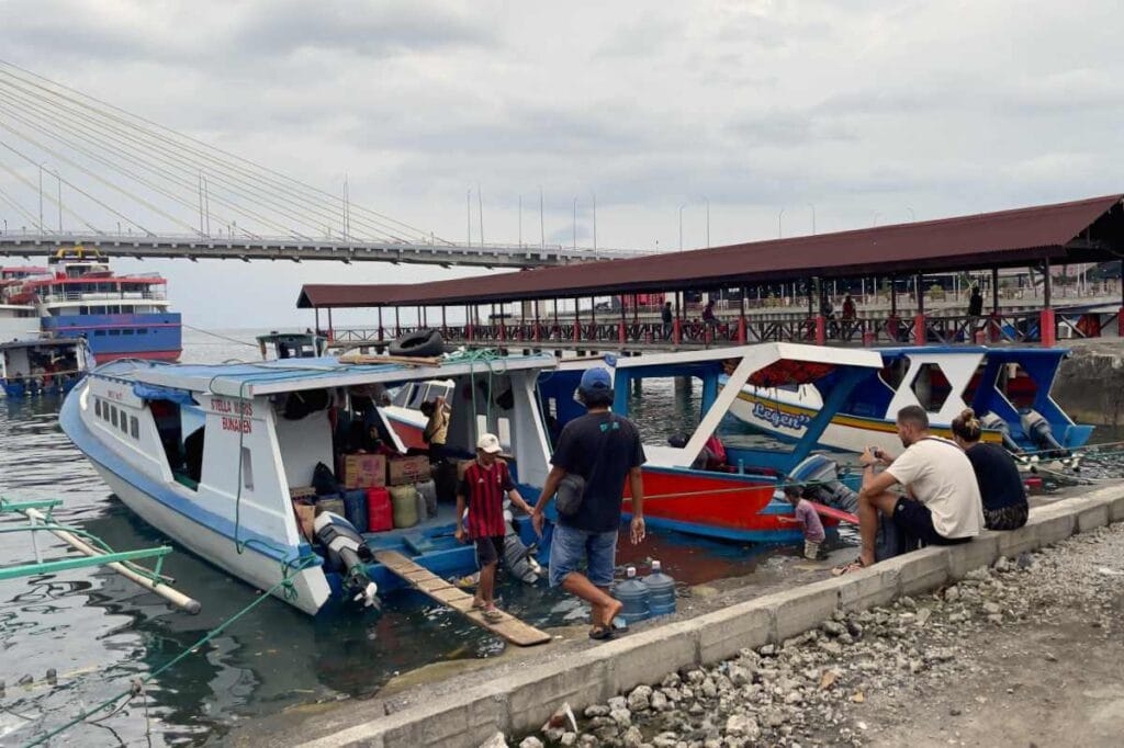 Manado Bunaken Harbor with boats and a scenic ocean view.