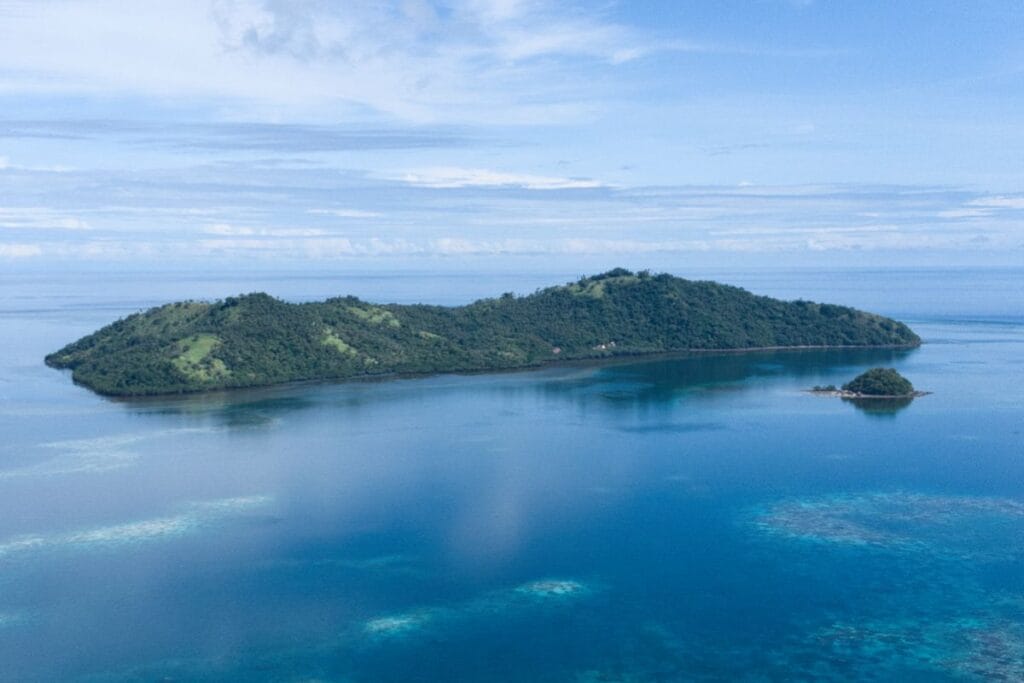Drone shot of Nain Island with clear water and tropical landscape.