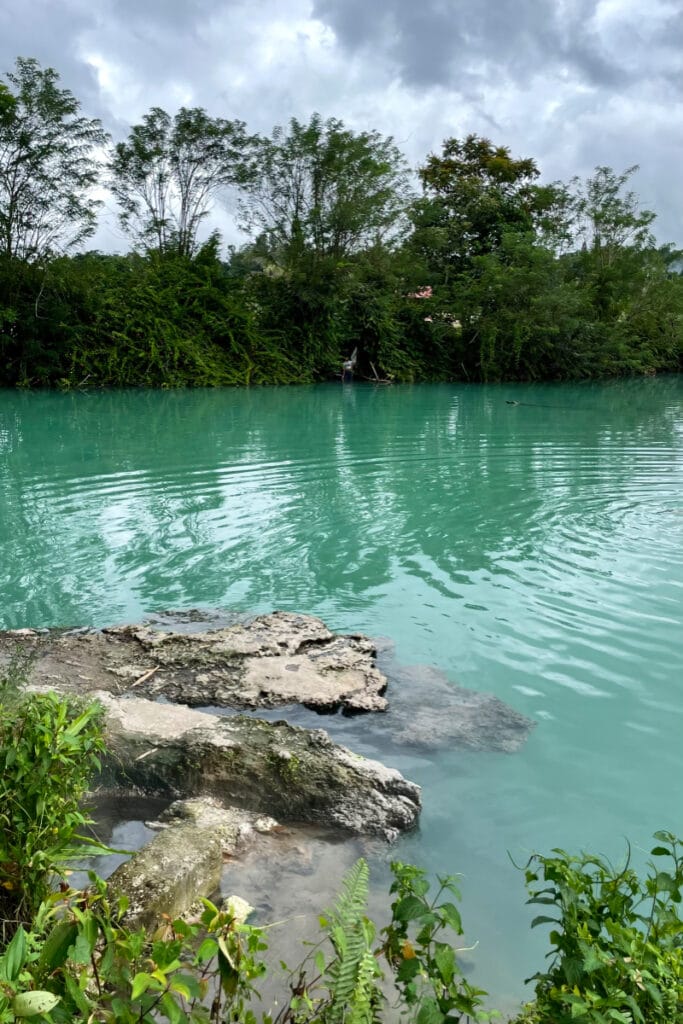 Ranolewo Hot Springs with vivid blue water in lush tropical Sulawesi