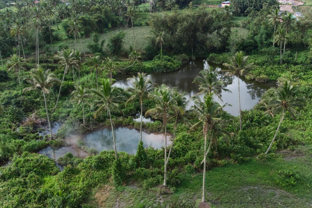 Two small lakes near Ranolewo Hot Springs in Sulawesi surrounded by greenery